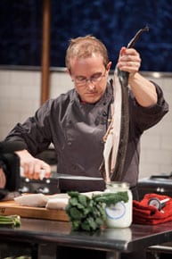 Chef Phillip quickly fillets a whole fish during Round 2 on Food Network's Chopped.